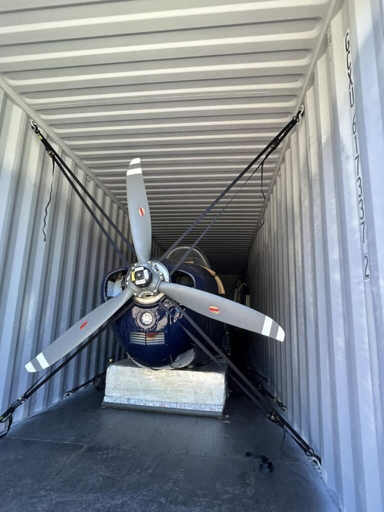 Beechcraft T-34 Mentor aircraft being disassembled and containerized by Neel Aviation for overseas shipment