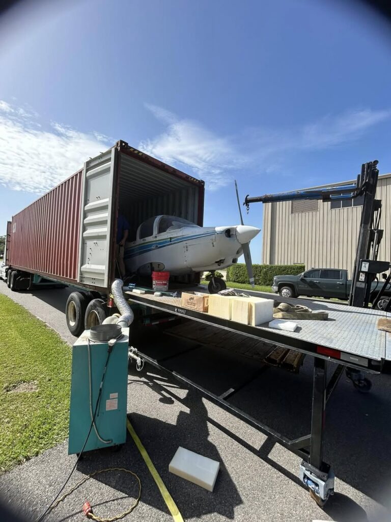 Cessna 310 aircraft and spare engines being containerized by Neel Aviation for shipment to South Korea